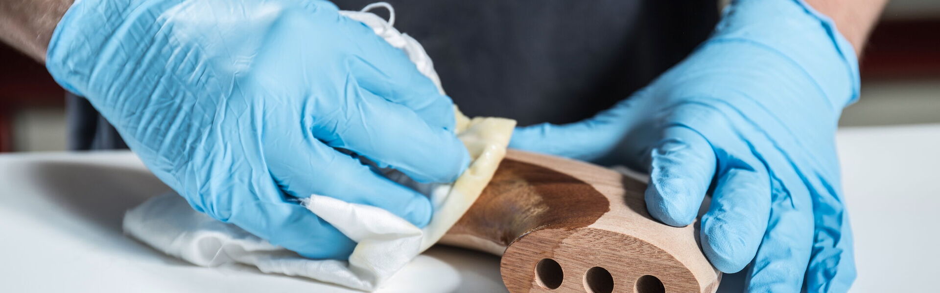 A man polishes a piece of wood.